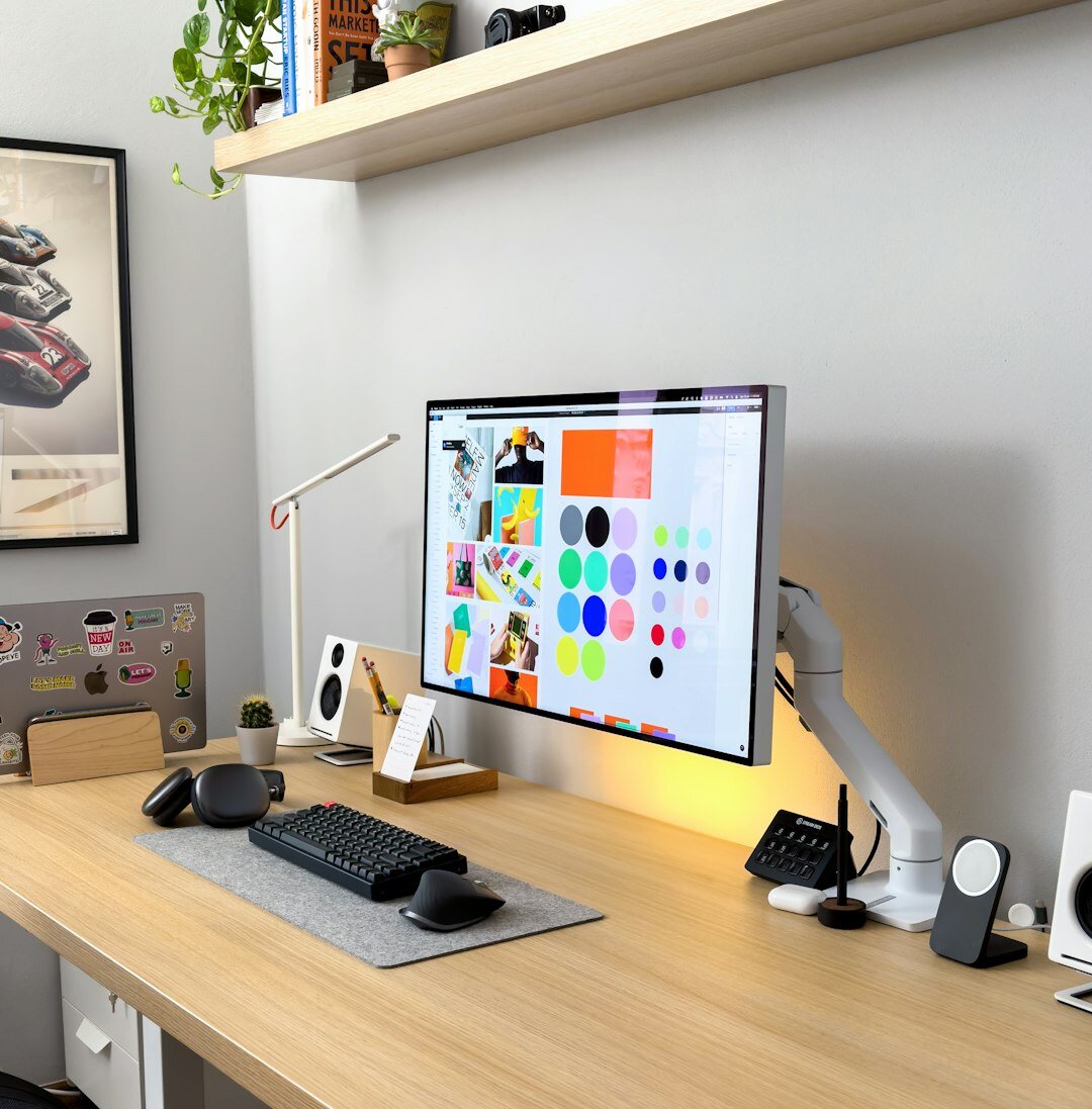 Portuguese audio producer editing sound waveforms on a laptop at a studio desk