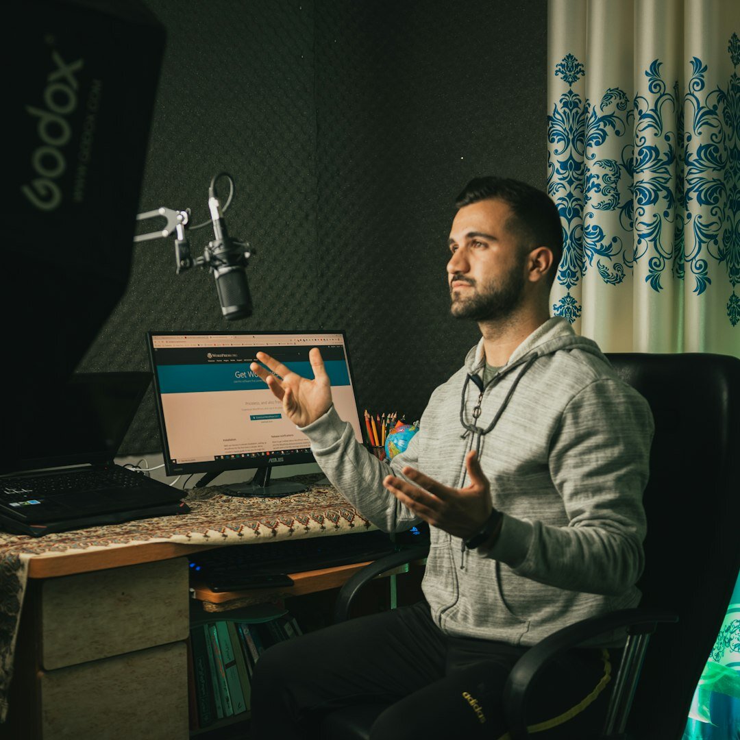 Young Portuguese woman podcast host speaking into a professional microphone in a modern recording studio