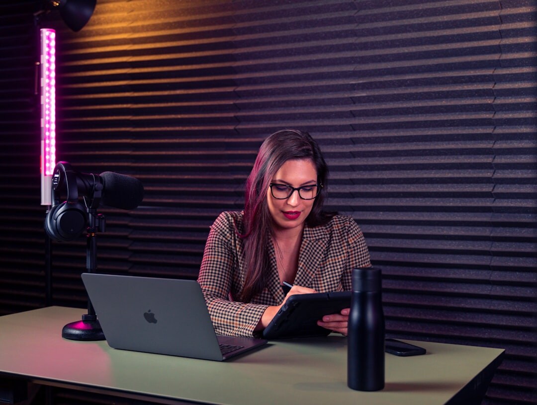 person editing podcast on laptop